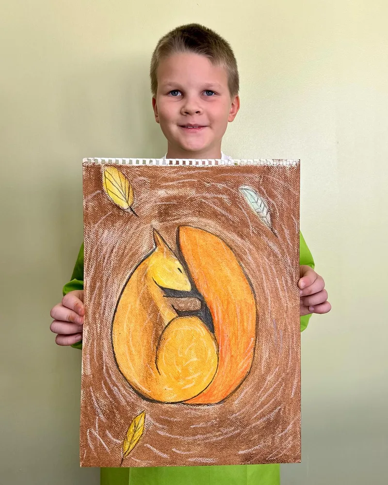 Student with his finished squirrel painting